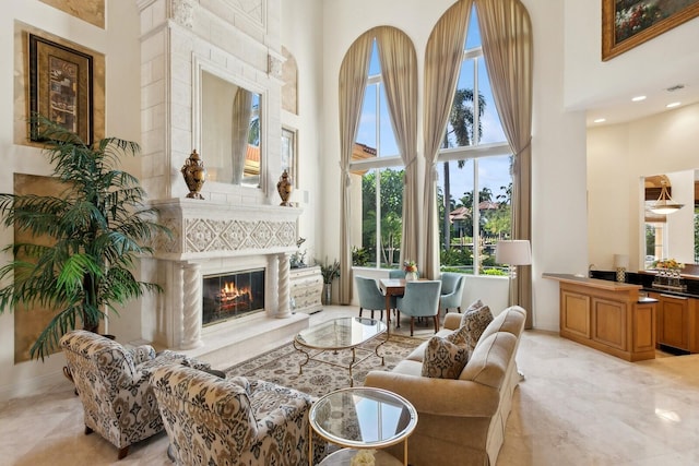 living room with a high ceiling and light tile patterned flooring