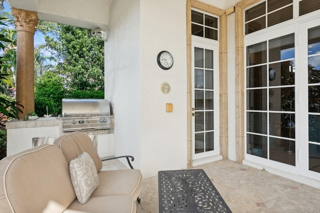 exterior space with area for grilling, a patio area, and french doors