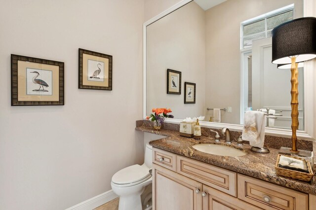 bathroom featuring toilet and vanity