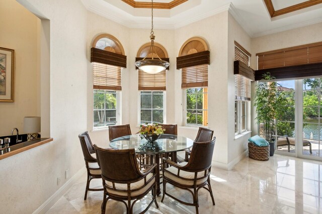 kitchen featuring dishwasher, sink, ceiling fan, a tray ceiling, and a center island with sink