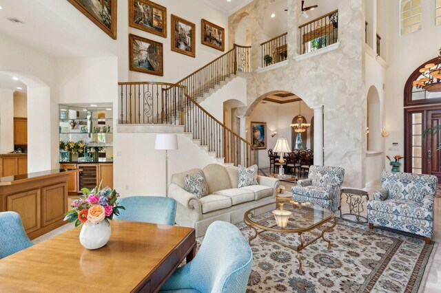 kitchen with custom range hood, crown molding, stainless steel appliances, a breakfast bar area, and decorative backsplash