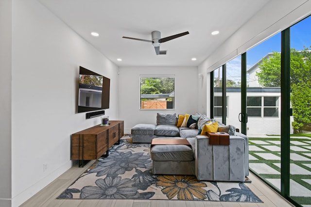 living room featuring light wood-type flooring and ceiling fan