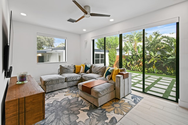 living room featuring light wood-type flooring and ceiling fan