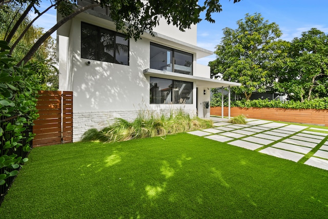 back of property with a lawn