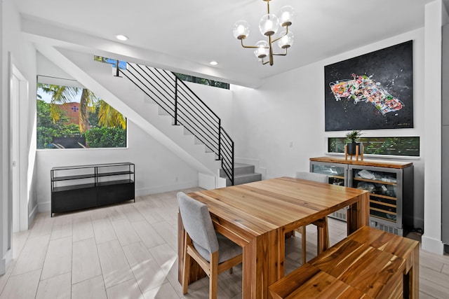 dining space featuring beverage cooler and an inviting chandelier