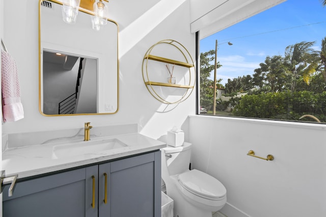 bathroom featuring toilet and vanity