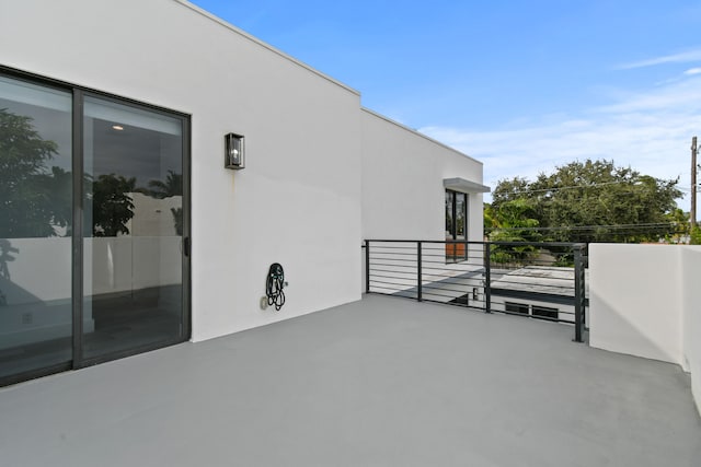 view of patio featuring a balcony