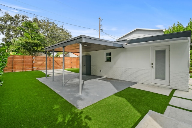 back of property with a patio and a yard