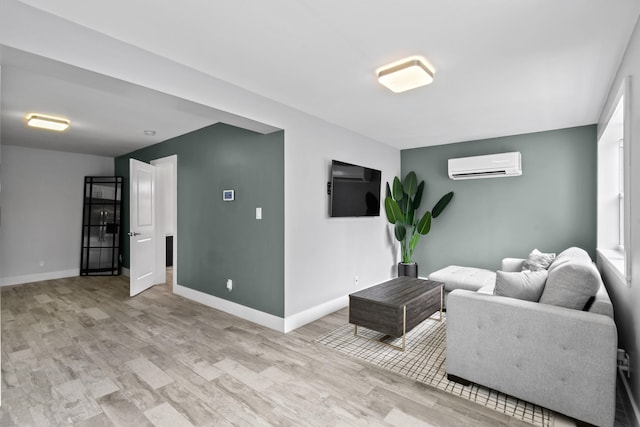 living room featuring light wood-type flooring and an AC wall unit