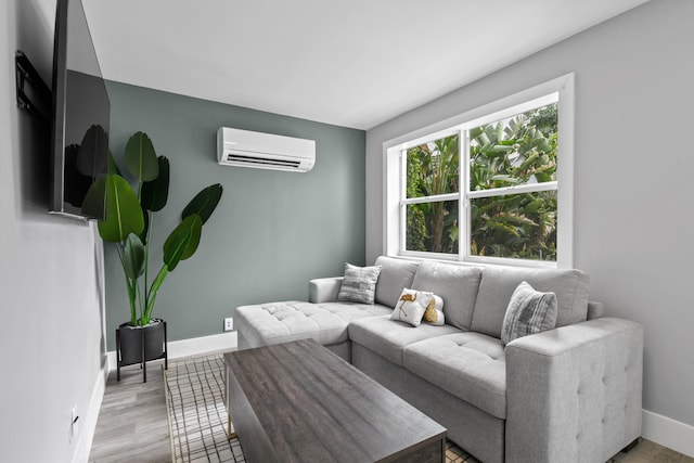 living room featuring a wall mounted AC and light wood-type flooring