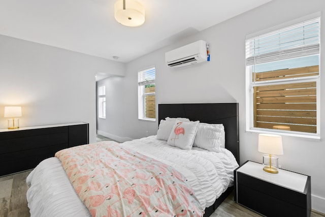 bedroom featuring an AC wall unit and wood-type flooring