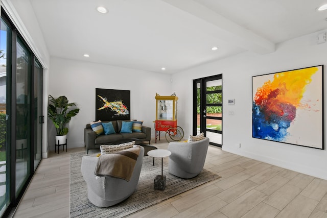 living room with light wood-type flooring and beamed ceiling