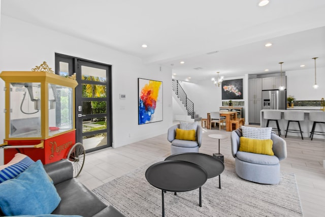 living room featuring a chandelier and light hardwood / wood-style flooring