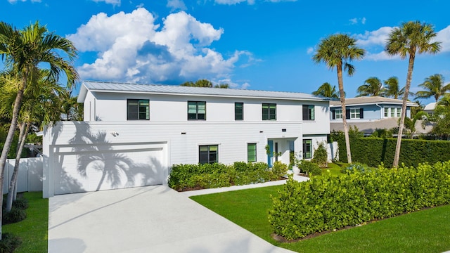 view of front of home featuring a front yard and a garage