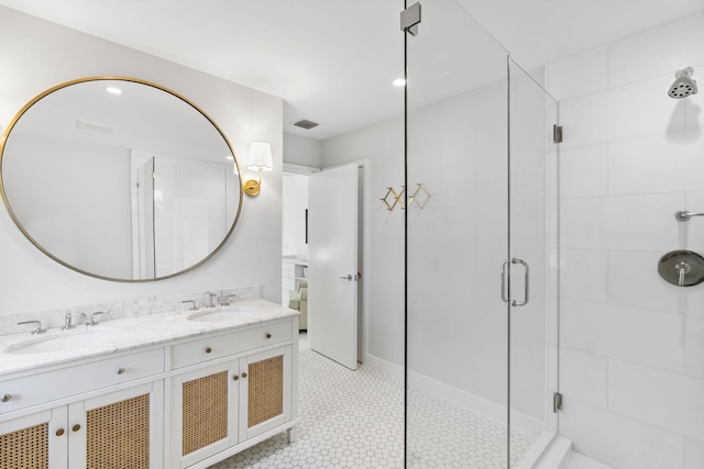 bathroom with a shower with door and vanity