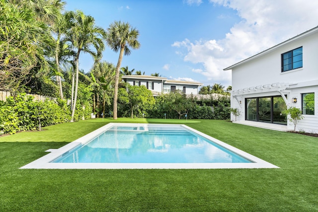 view of pool with a pergola and a lawn