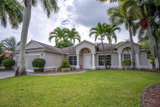 ranch-style home with a front lawn