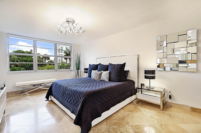 tiled bedroom featuring a chandelier