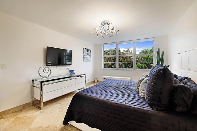 bedroom featuring light tile patterned flooring and a chandelier