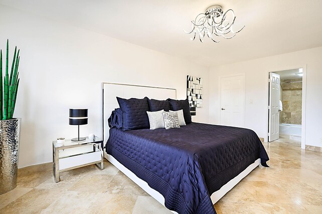 tiled bedroom featuring ensuite bath