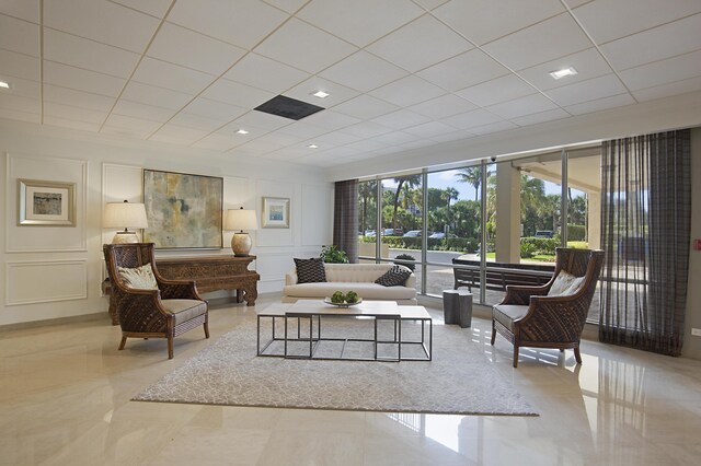 tiled living room with a drop ceiling