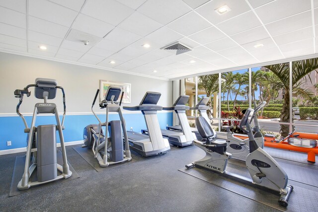 workout area with a drop ceiling and floor to ceiling windows