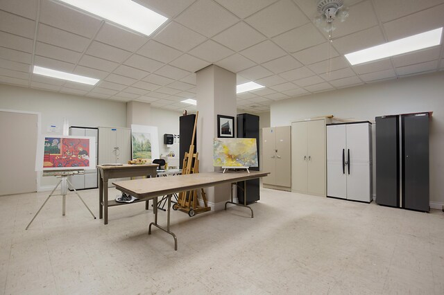 dining room featuring a paneled ceiling and light tile patterned floors