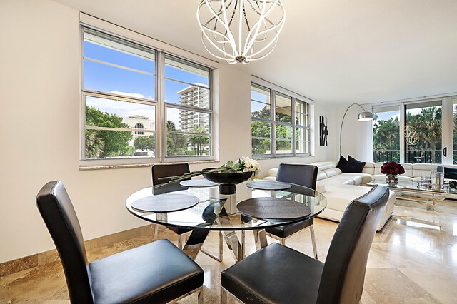 tiled dining area with a chandelier