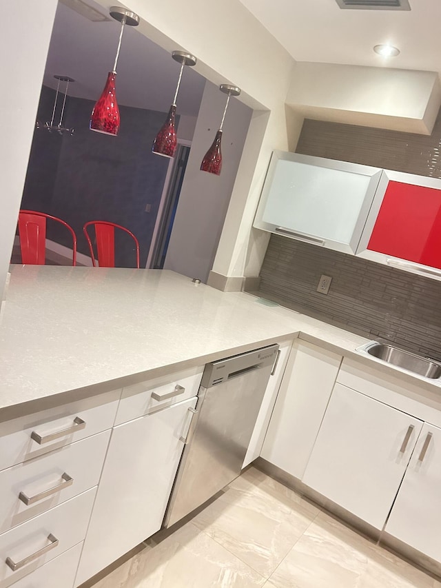 kitchen with sink, dishwasher, tasteful backsplash, white cabinets, and decorative light fixtures