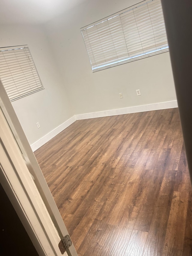 empty room with dark hardwood / wood-style floors