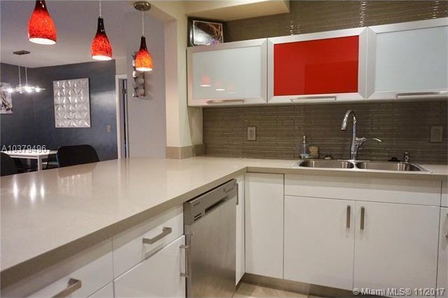 kitchen with sink, white cabinetry, stainless steel dishwasher, pendant lighting, and decorative backsplash