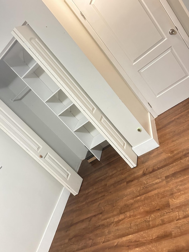 hall with dark wood-type flooring