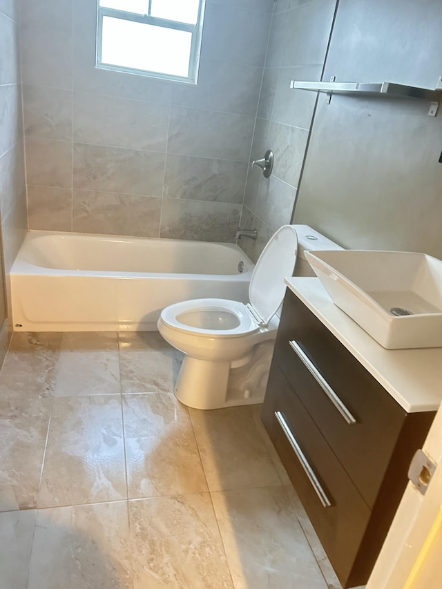 full bathroom featuring vanity, toilet, and tiled shower / bath combo