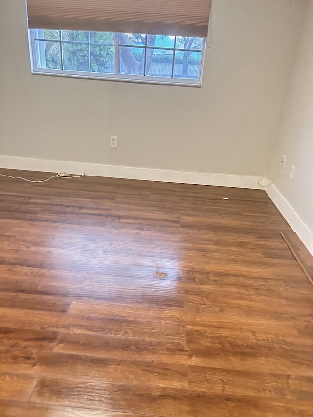 empty room featuring dark wood-type flooring