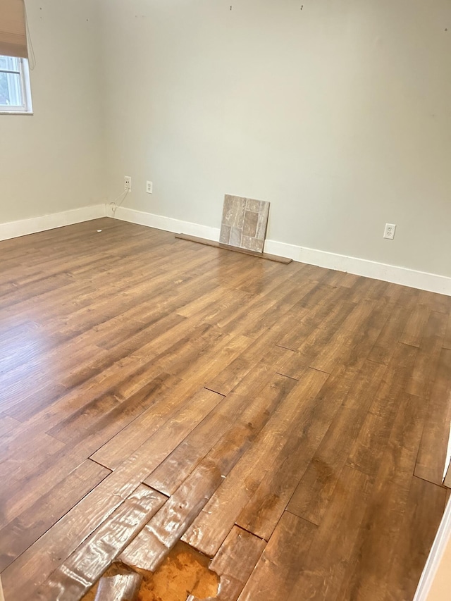 unfurnished room with wood-type flooring