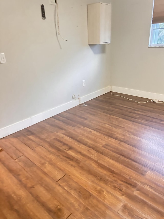 empty room with dark wood-type flooring