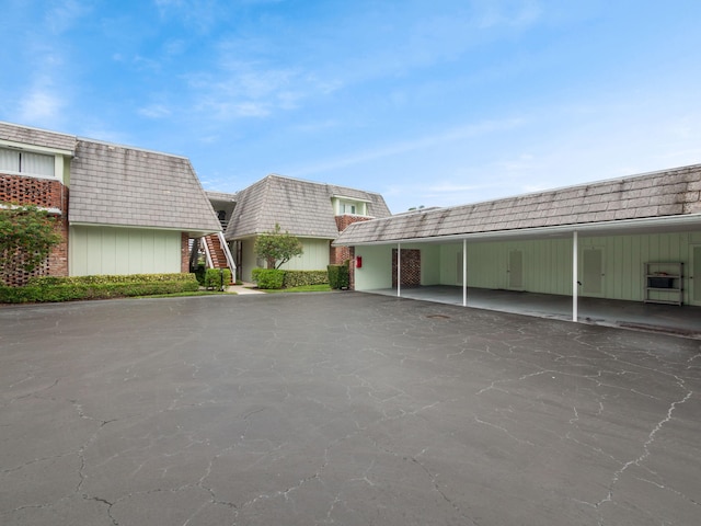 view of parking / parking lot featuring a carport