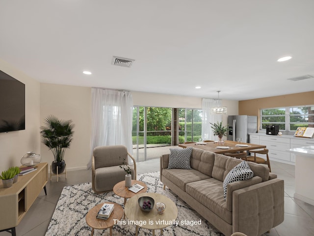 tiled living room with an inviting chandelier