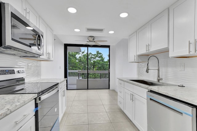 kitchen with white cabinets, sink, stainless steel appliances, and ceiling fan