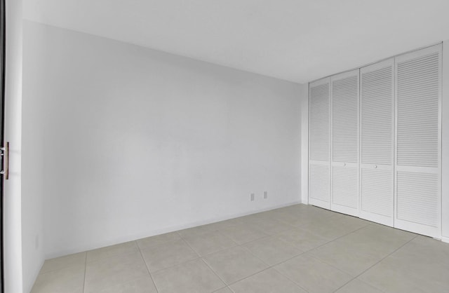 interior space featuring light tile patterned floors and a closet