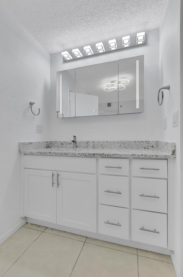 bathroom featuring vanity, a textured ceiling, and tile patterned floors