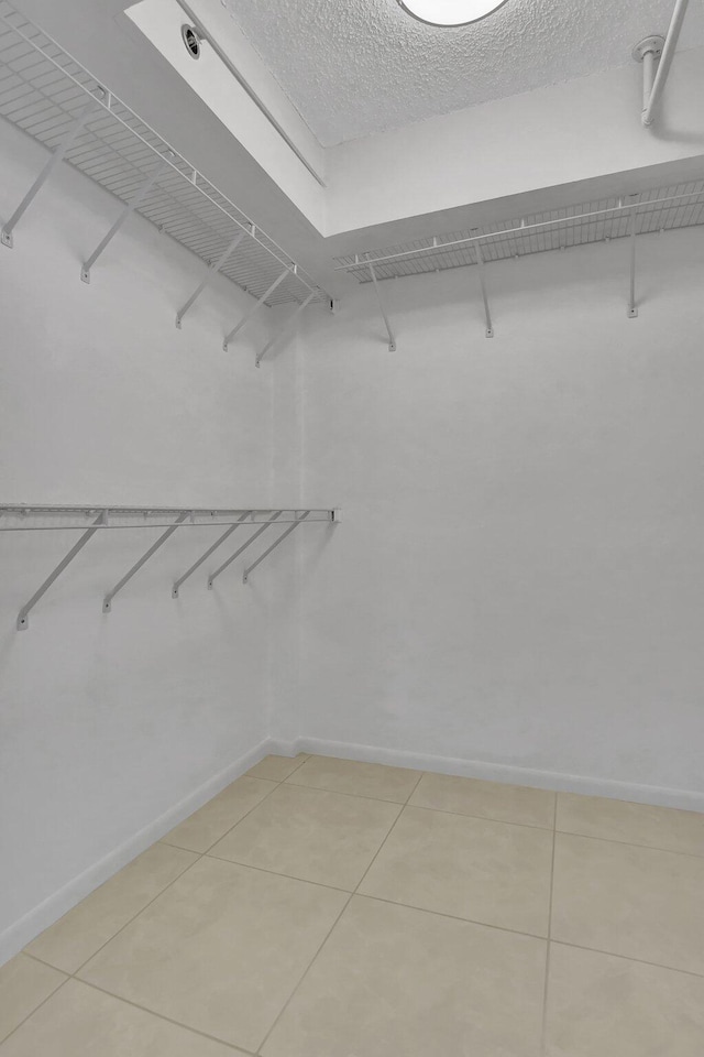 spacious closet featuring light tile patterned floors