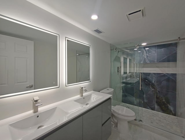 bathroom featuring a shower with door, vanity, and toilet