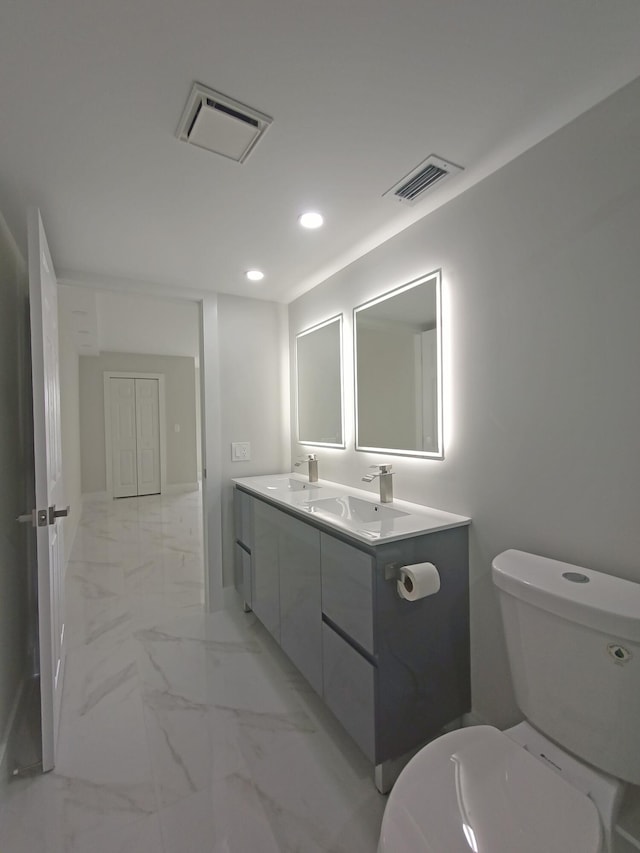 bathroom with toilet and vanity