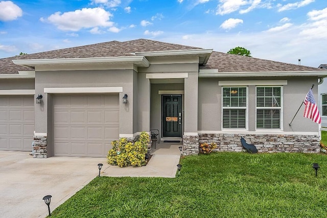 view of front of home with a front yard and a garage