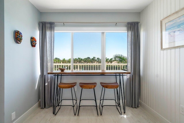 dining area with baseboards and wood finished floors