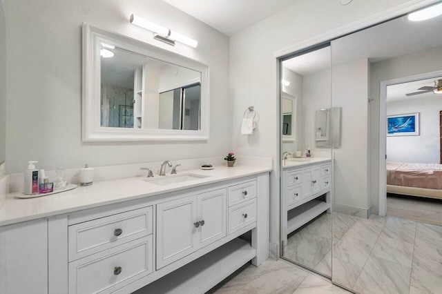 full bathroom featuring baseboards, marble finish floor, a ceiling fan, vanity, and ensuite bath