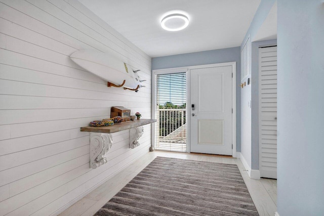 mudroom with baseboards and wood finished floors