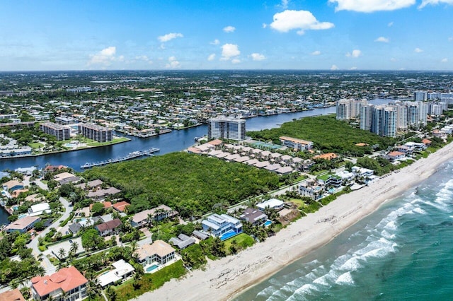 drone / aerial view with a beach view and a water view