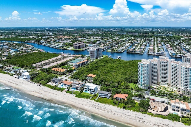 bird's eye view with a water view, a view of the beach, and a view of city